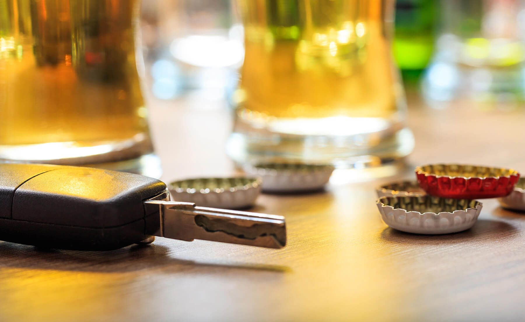 keys in front of bottle caps and beers