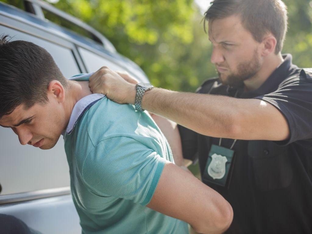 police officer arresting college student