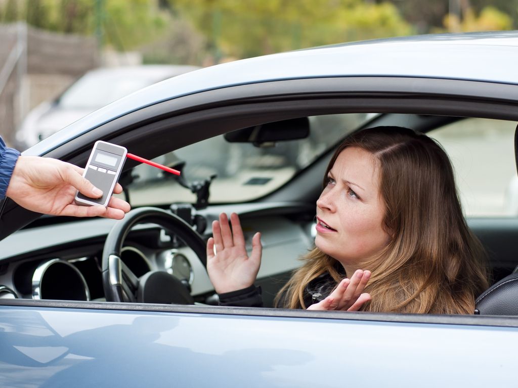 woman getting a breathalyzer test