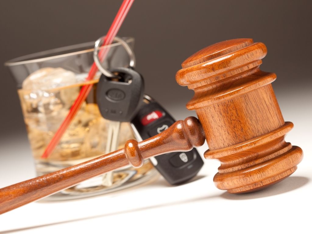 gavel in front of mixed drink with car keys