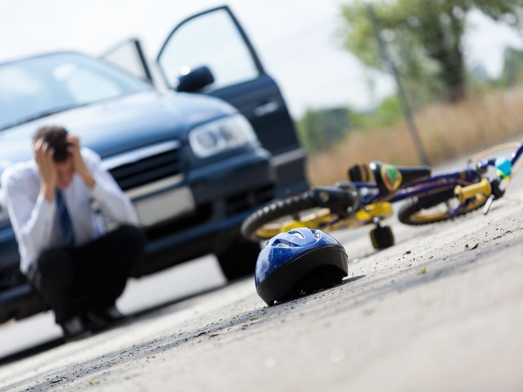 man holds head with hands after committing vehicular homicide while drunk driving