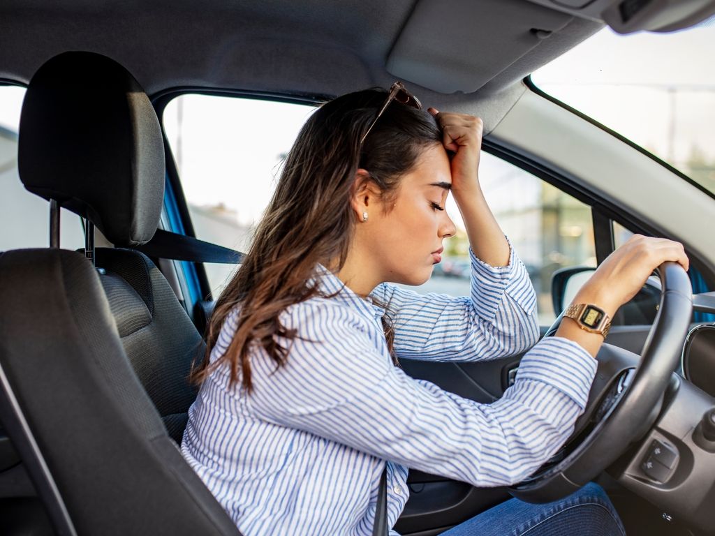 Teen putting fist against her head from being pulled over for a DUI