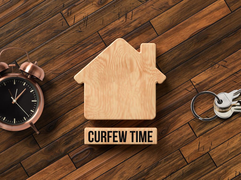 wooden block of house with keys and clock