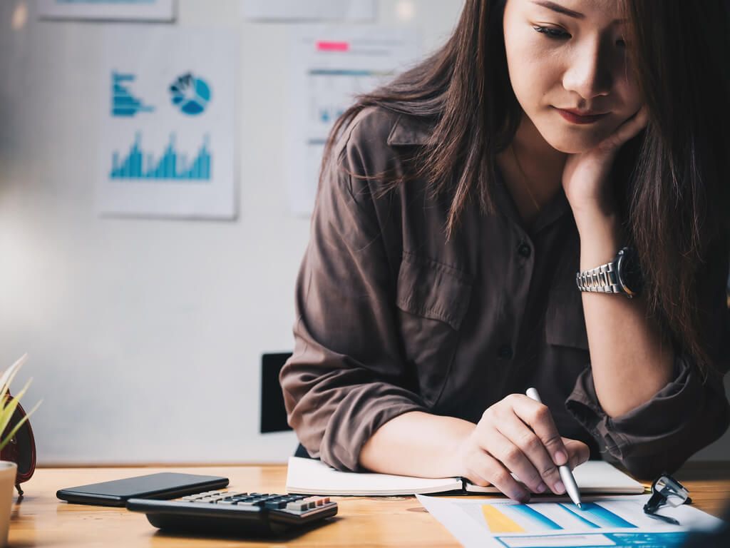 woman reviewing tax forms and documents