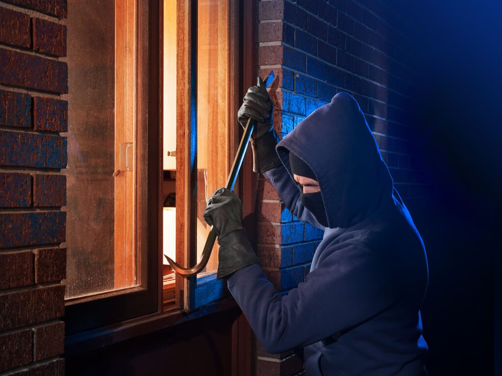 burglar breaking into a home