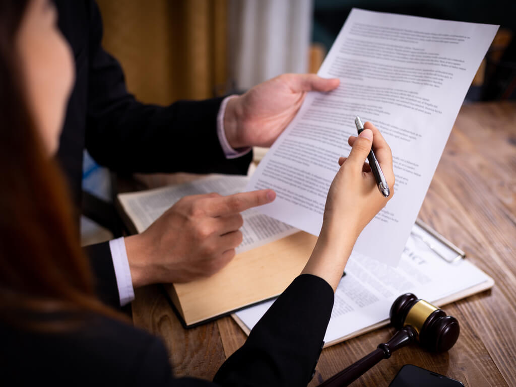 two people reviewing legal documents