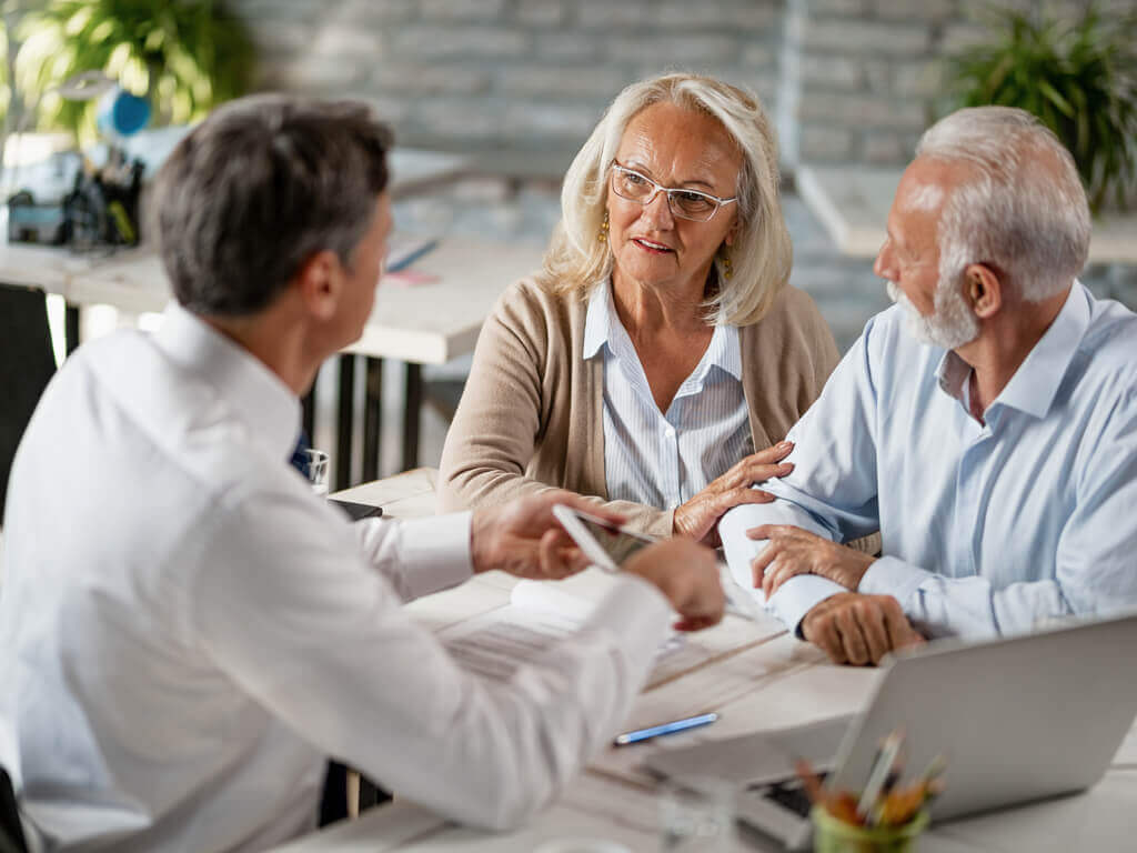 an older couple meeting with an estate planning attorney